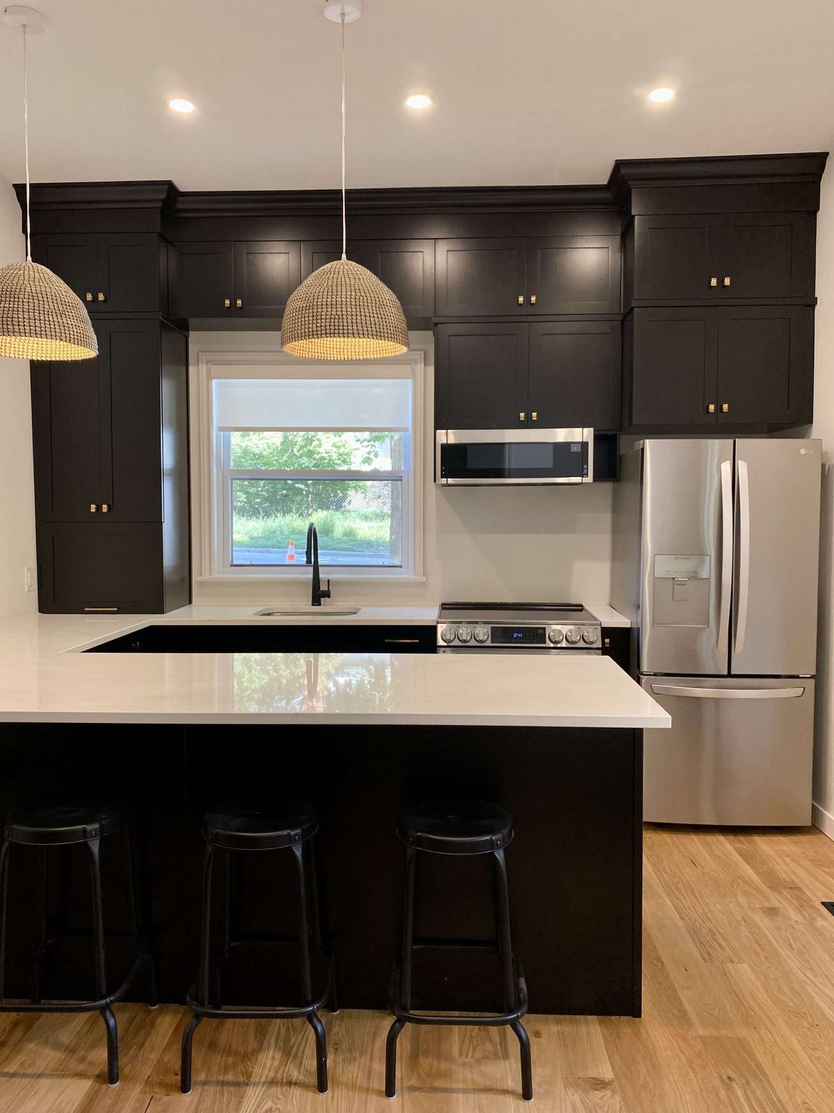Dark modern kitchen with an island and bar stools